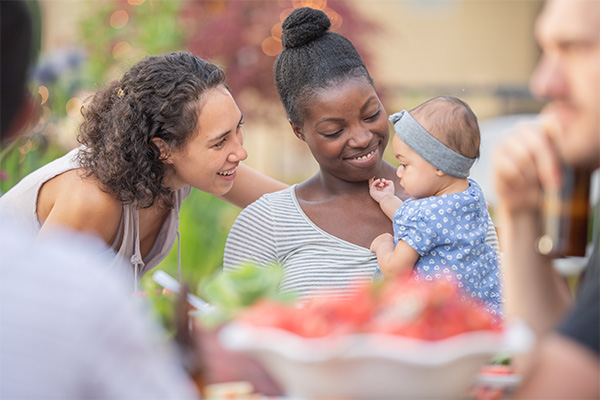 A group of young adult friends dining al fresco on a patio
